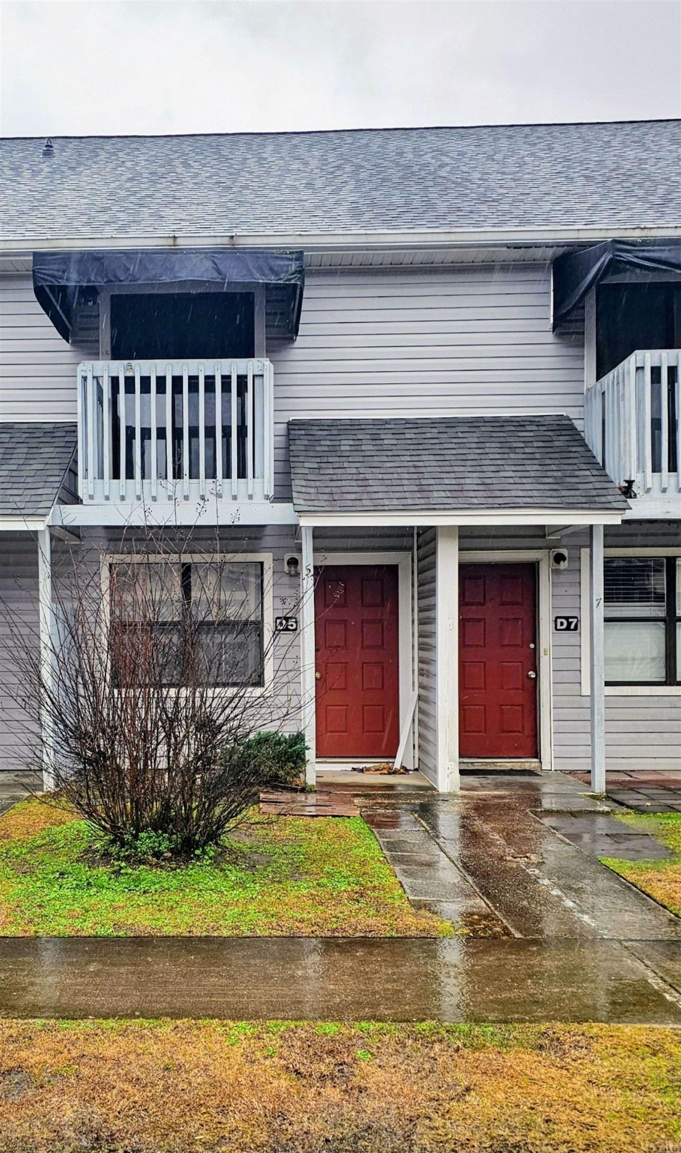 View of exterior entry with a shingled roof