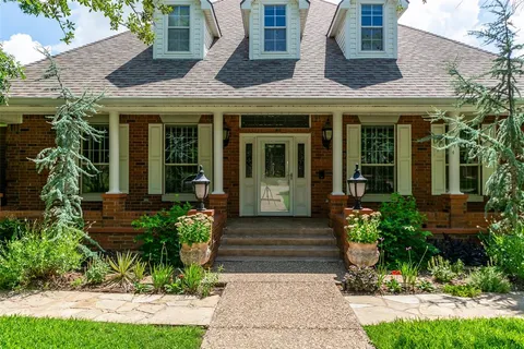 a front view of a house with garden
