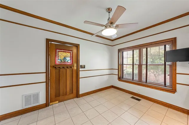 a view of empty room with a ceiling fan and window