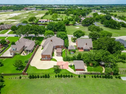 an aerial view of a house with garden space and outdoor seating