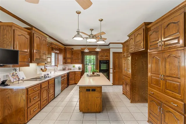a large kitchen with stainless steel appliances granite countertop a stove and a sink