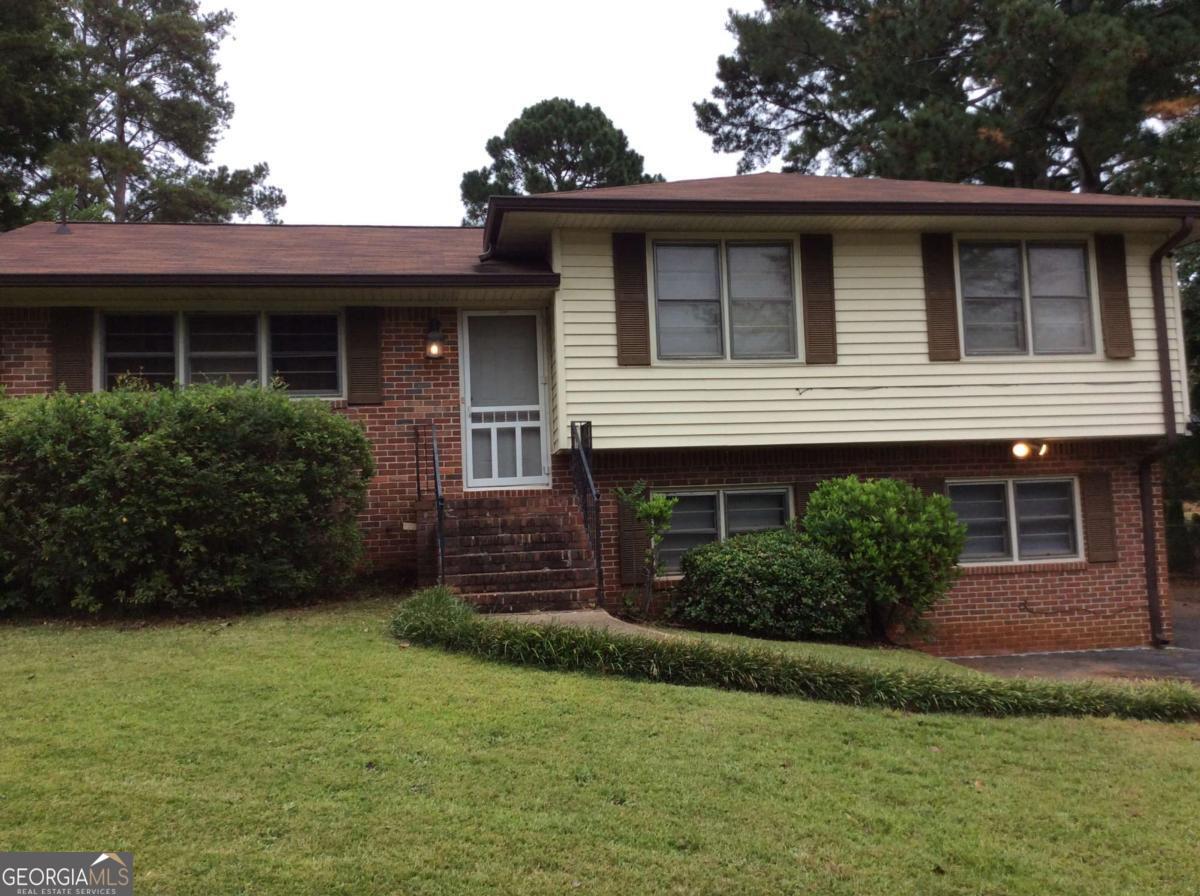 a front view of a house with a yard