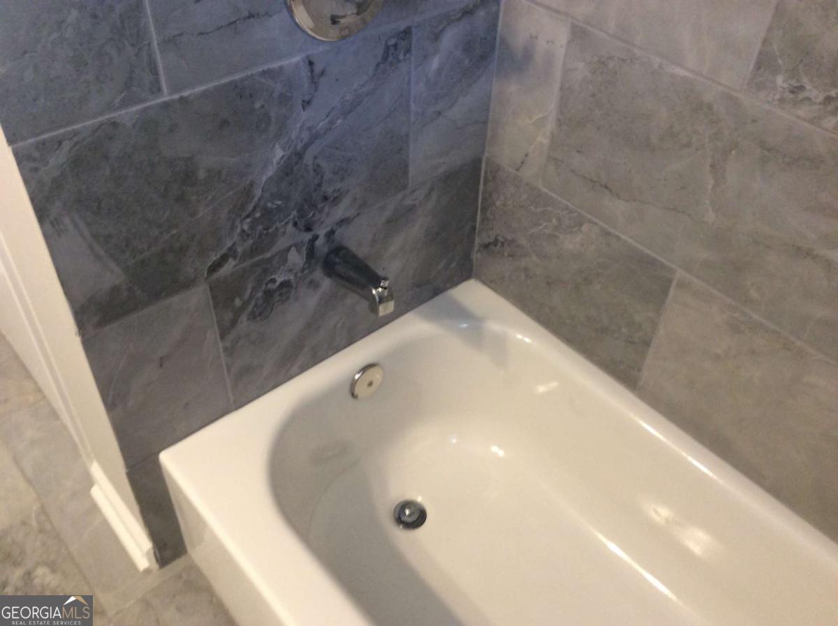 209 Decatur Road McDonough, GA 30253 - Photo 12 of 25 a bathroom with a tub