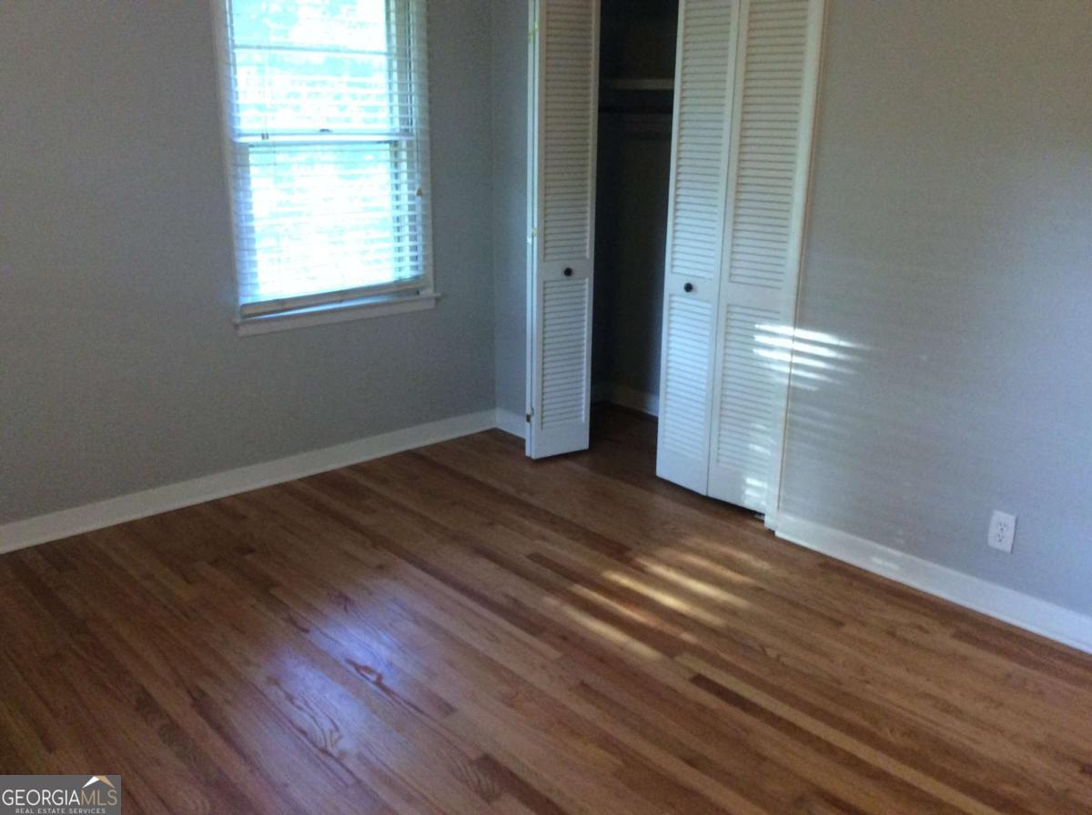 209 Decatur Road McDonough, GA 30253 - Photo 17 of 25 an empty room with wooden floor and windows