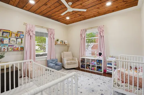 a living room with furniture and baby crib