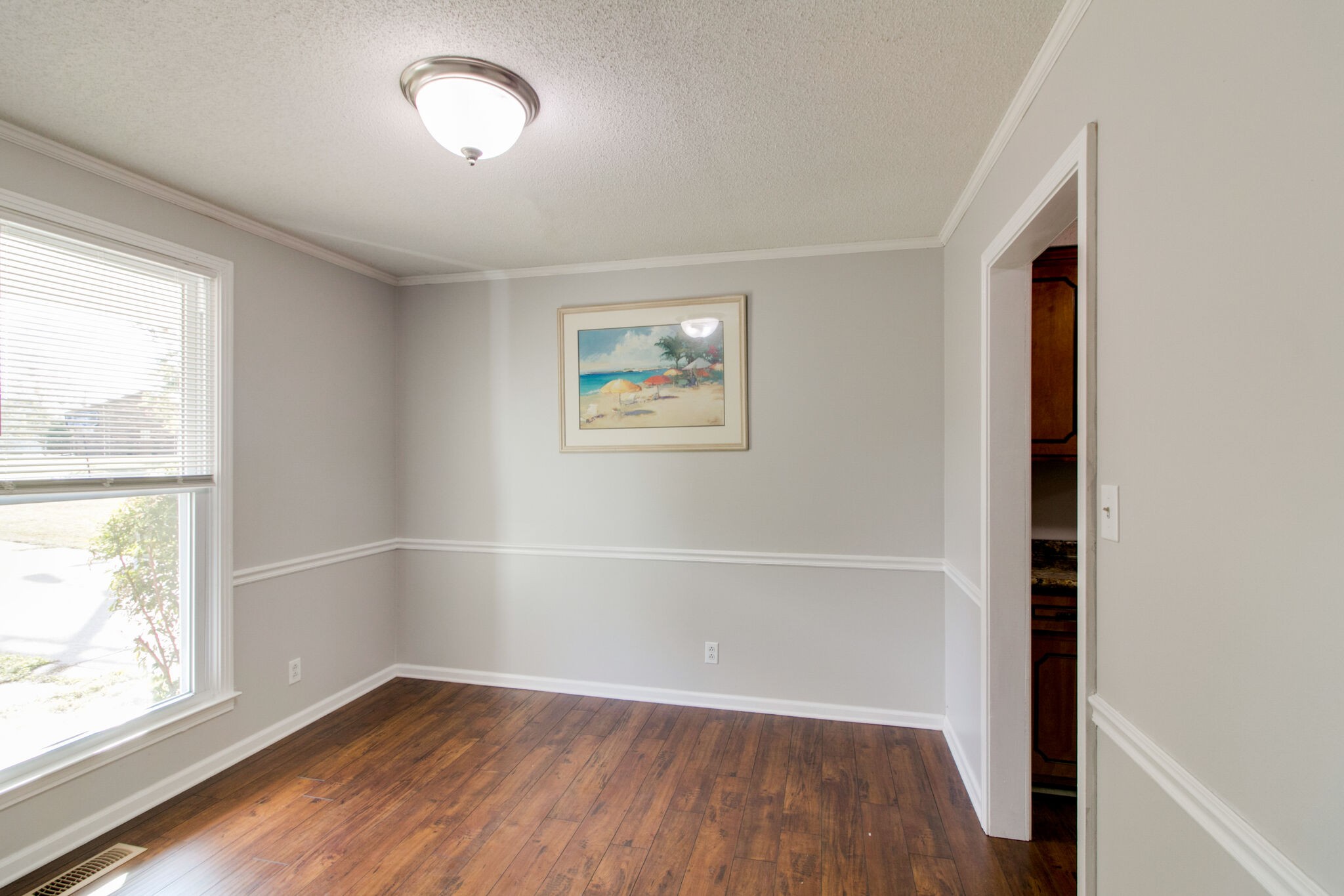 920 Dominion Drive Clarksville, TN 37042 - Photo 13 of 28 an empty room with wooden floor and windows