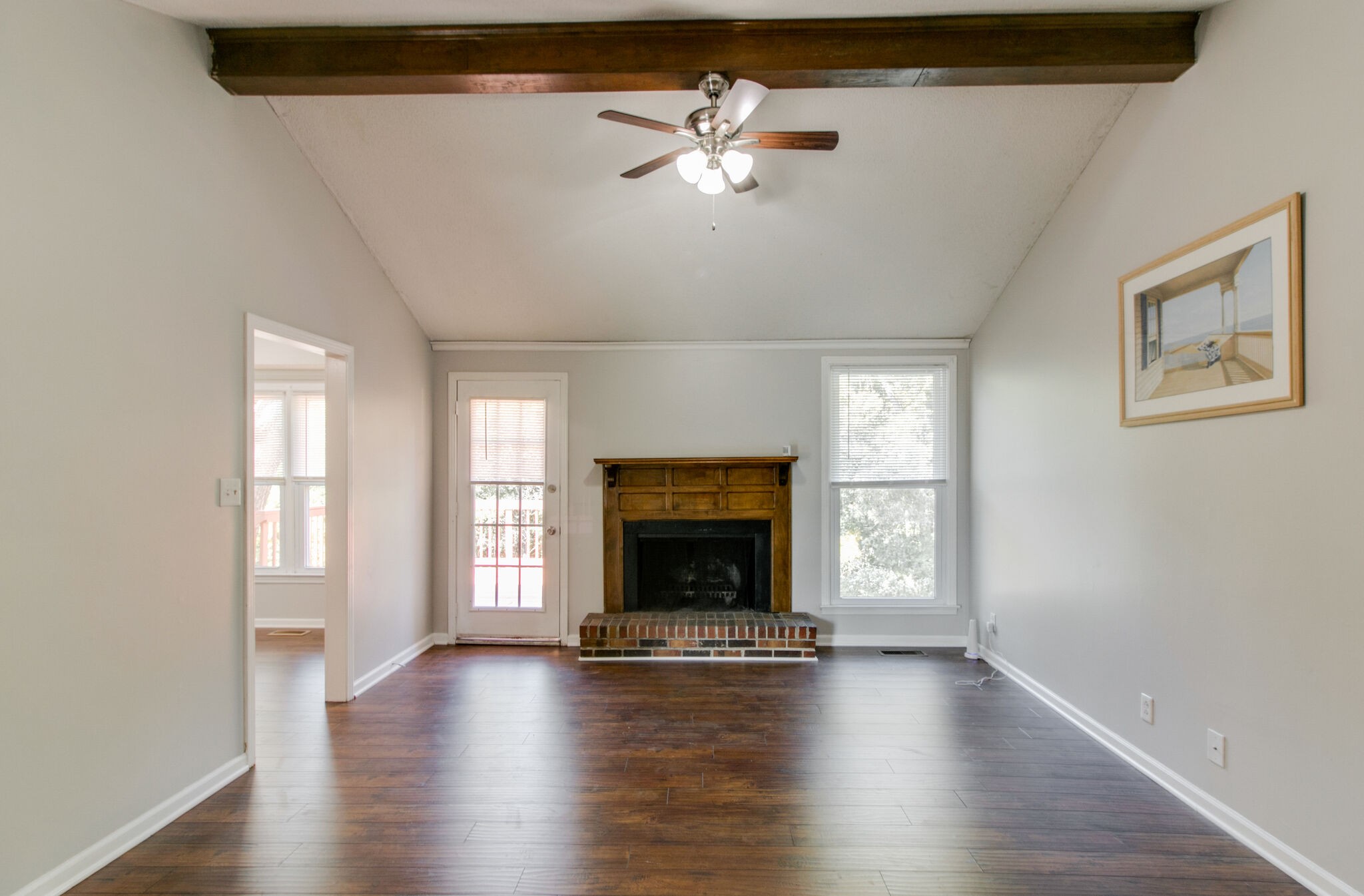 920 Dominion Drive Clarksville, TN 37042 - Photo 5 of 28 an empty room with windows fireplace and wooden floor