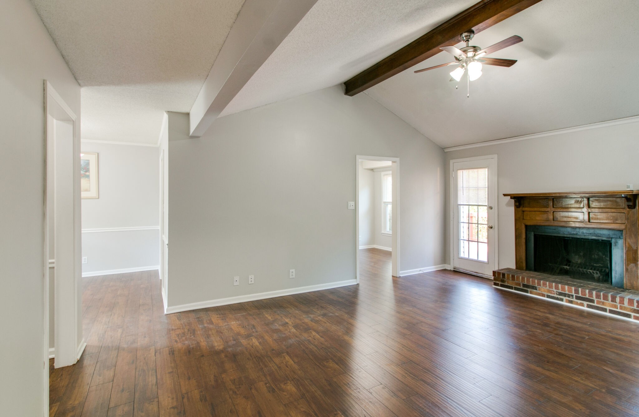 920 Dominion Drive Clarksville, TN 37042 - Photo 6 of 28 an empty room with wooden floor fireplace and windows