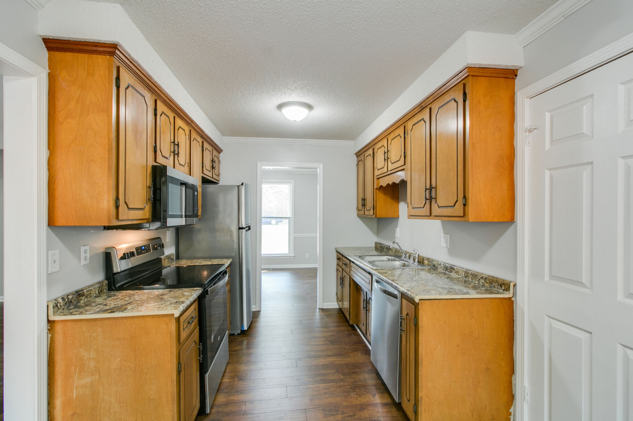 920 Dominion Drive Clarksville, TN 37042 - Photo 7 of 28 a kitchen with stainless steel appliances granite countertop a stove a sink and a refrigerator