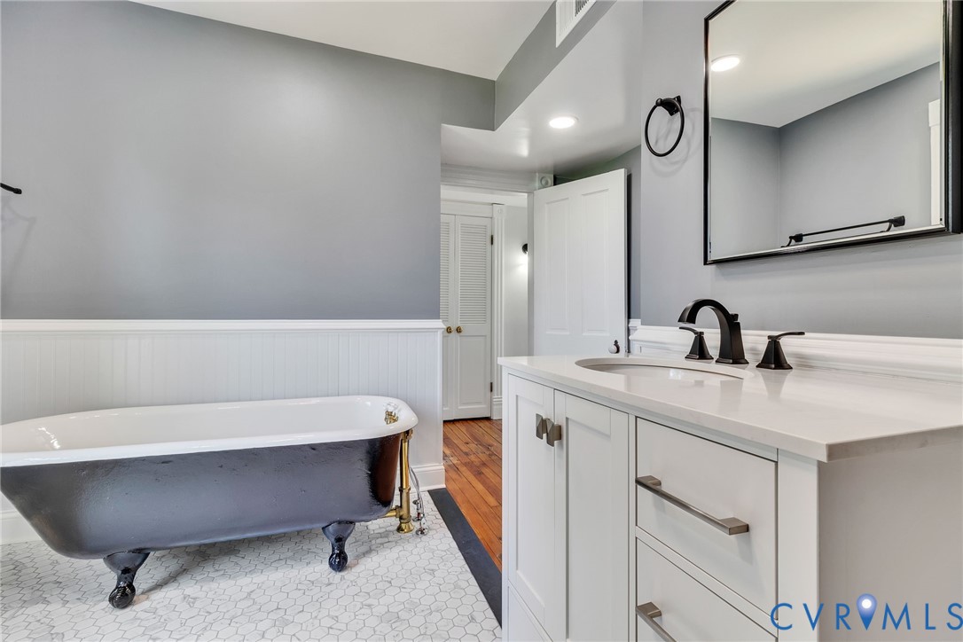 618 Main Street Reedville, VA 22539 - Photo 34 of 54 Bathroom featuring a black clawfoot tub, white hex