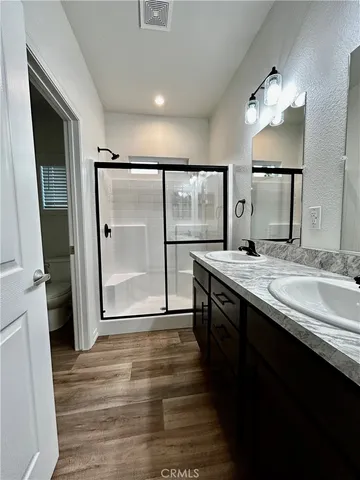 a bathroom with a shower sink and mirror