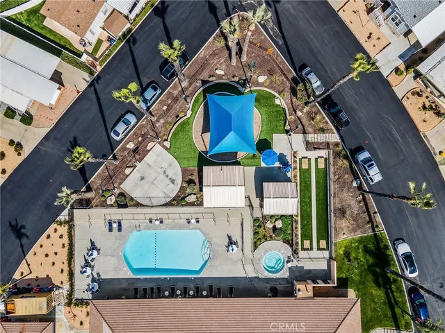 an aerial view of a house with a yard and fountain