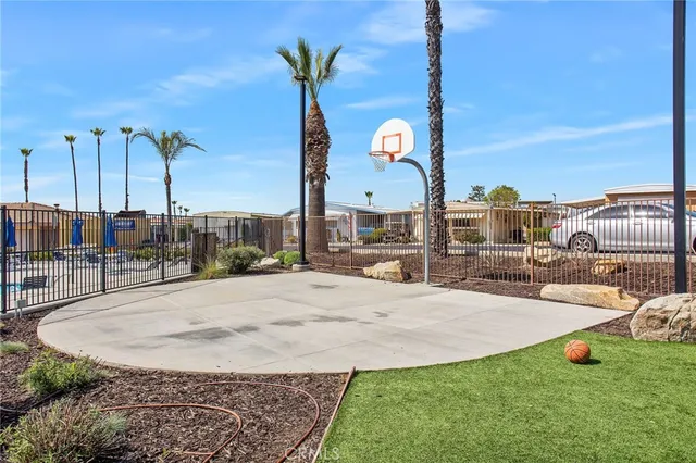 a view of a house with backyard sitting area and swimming pool