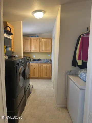 a utility room with sink dryer and washer