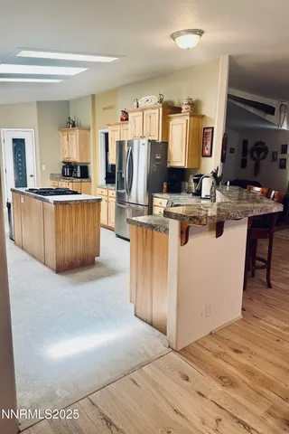 a kitchen with kitchen island cabinets and wooden floor