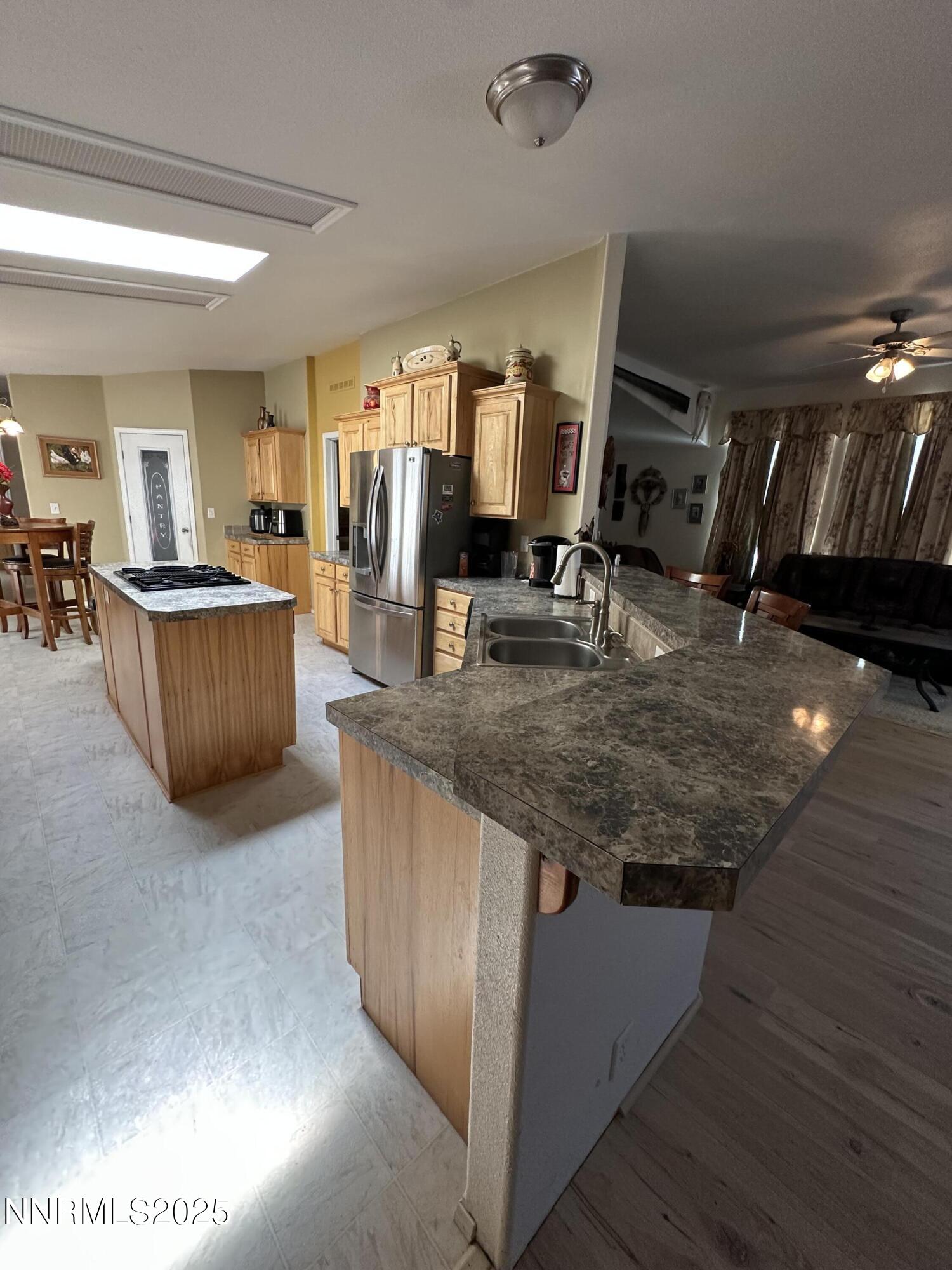 125 Spring Drive Lovelock, NV 89419 - Photo 8 of 12 a kitchen with counter top space and stainless steel appliances