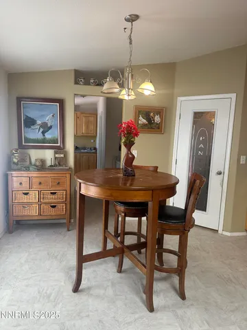 a view of a dining room with furniture and chandelier