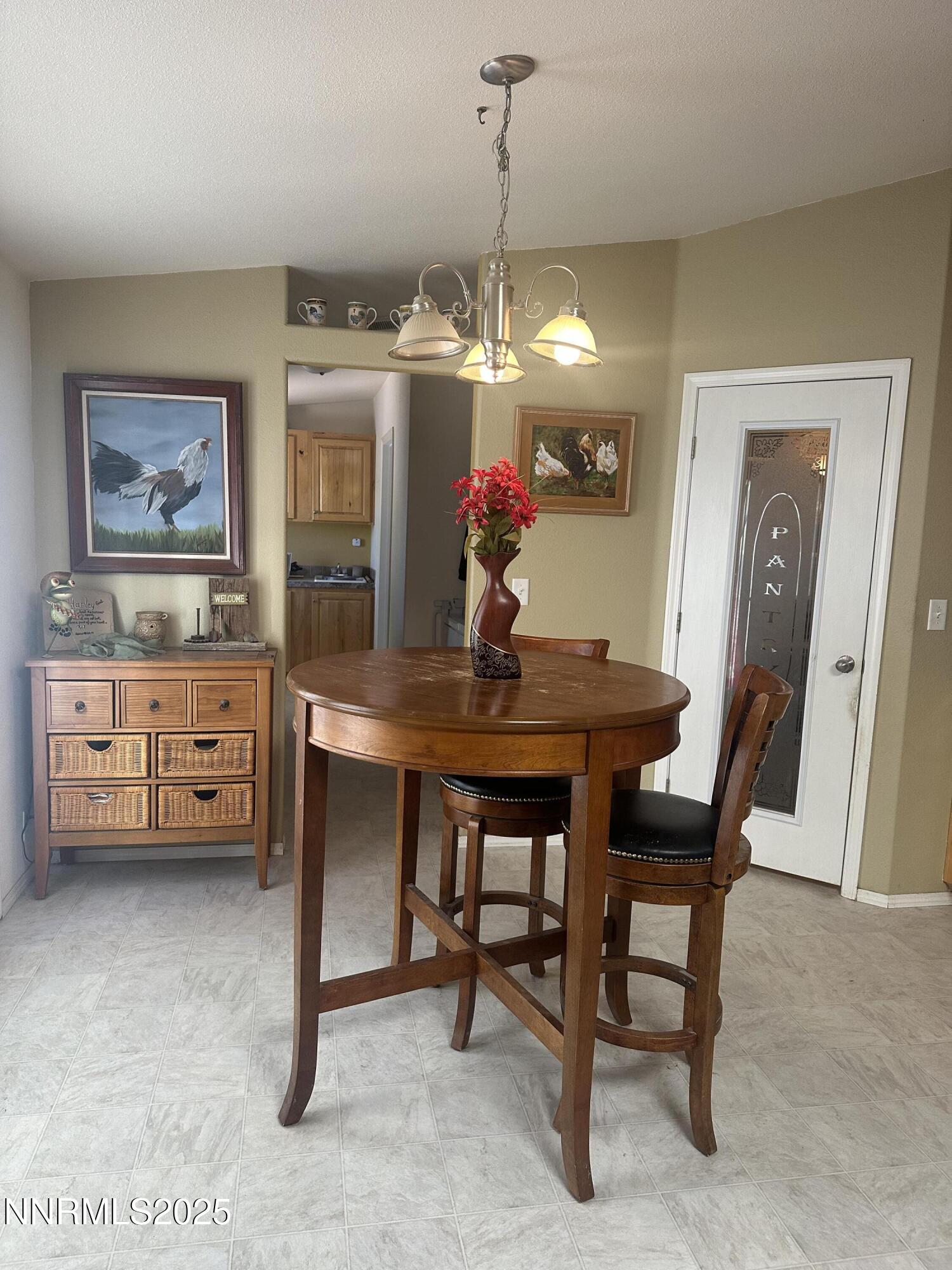 125 Spring Drive Lovelock, NV 89419 - Photo 9 of 12 a view of a dining room with furniture and chandelier