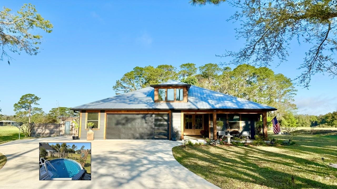 146 Maple Tree Lane Elkton, FL 32033 - Photo 1 of 75 a front view of a house with a yard table and chairs