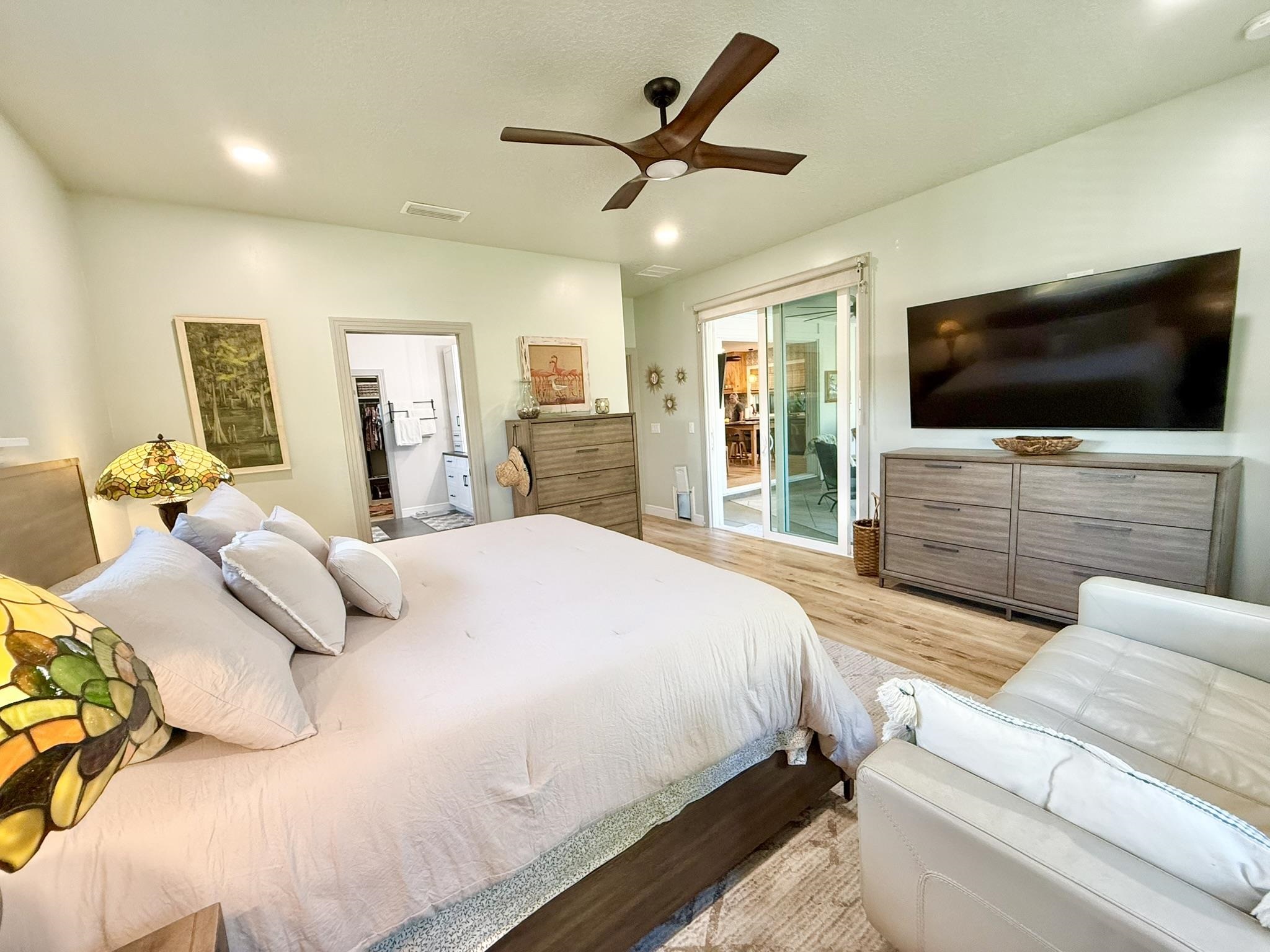 146 Maple Tree Lane Elkton, FL 32033 - Photo 24 of 75 a bedroom with a bed a flat screen tv and a couch