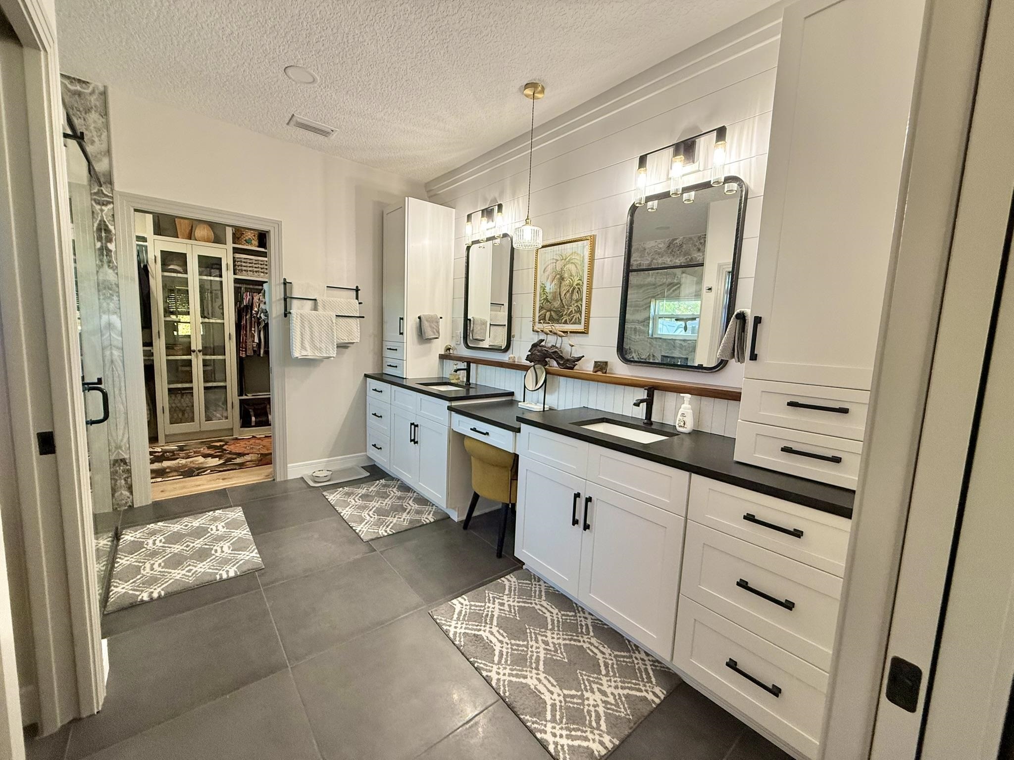 146 Maple Tree Lane Elkton, FL 32033 - Photo 25 of 75 a spacious bathroom with a double vanity sink a mirror and a shower