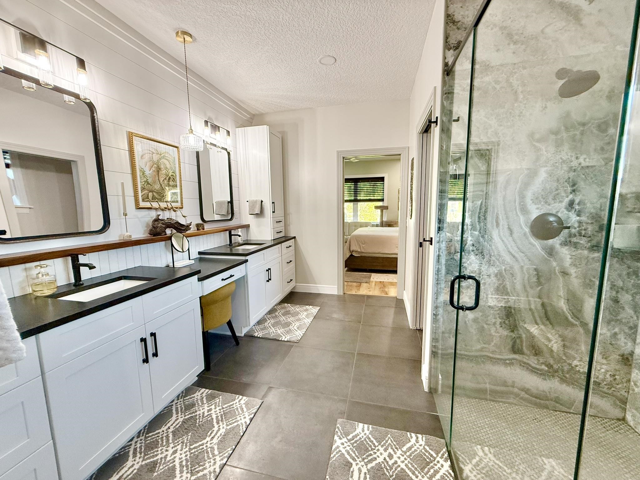 146 Maple Tree Lane Elkton, FL 32033 - Photo 30 of 75 a spacious bathroom with a granite countertop sink mirror and shower