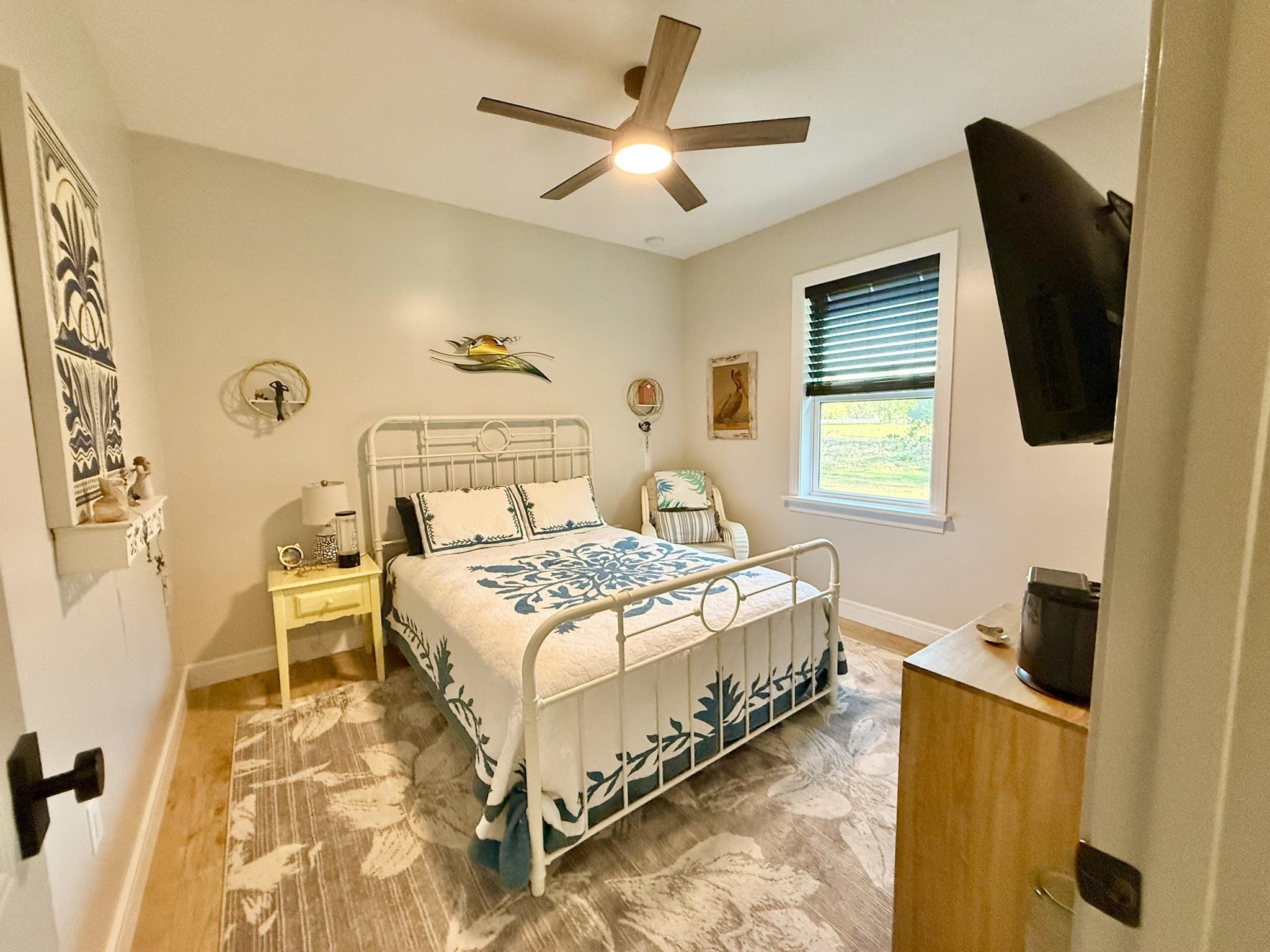 146 Maple Tree Lane Elkton, FL 32033 - Photo 38 of 75 a bedroom with a bed and wooden floor