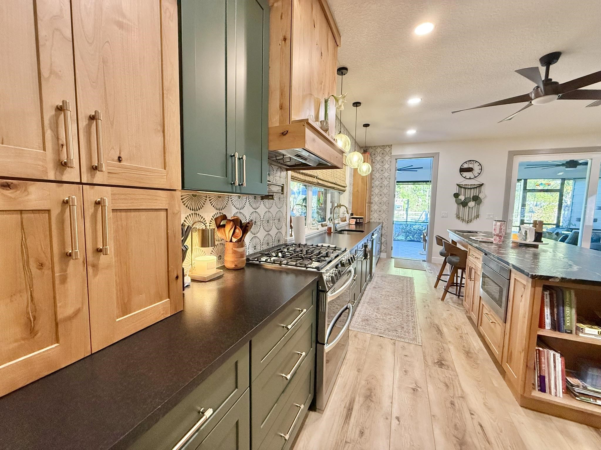146 Maple Tree Lane Elkton, FL 32033 - Photo 42 of 75 a kitchen with stainless steel appliances granite countertop a refrigerator a stove and a wooden floors