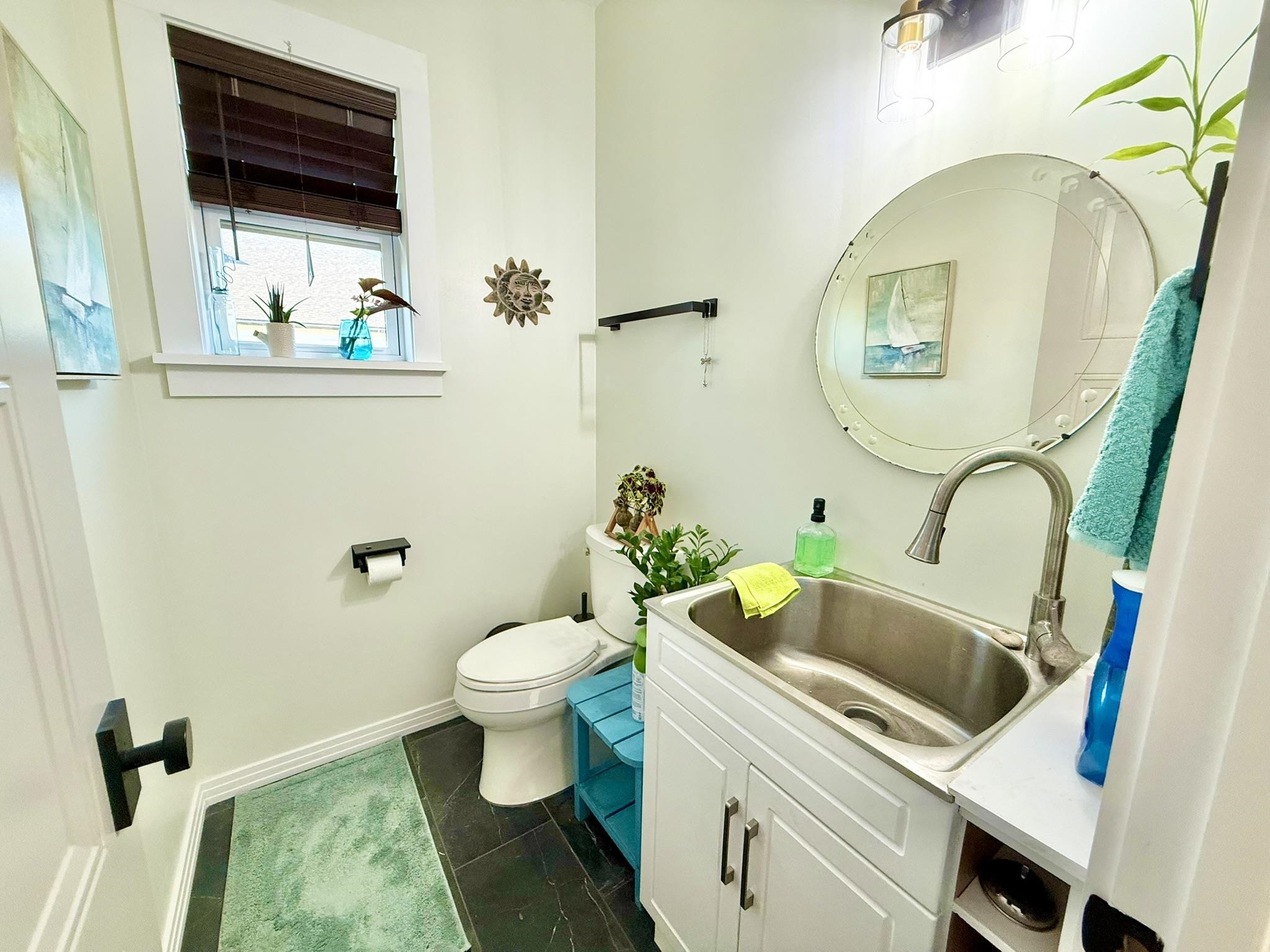 146 Maple Tree Lane Elkton, FL 32033 - Photo 56 of 75 a bathroom with a sink a toilet and a mirror
