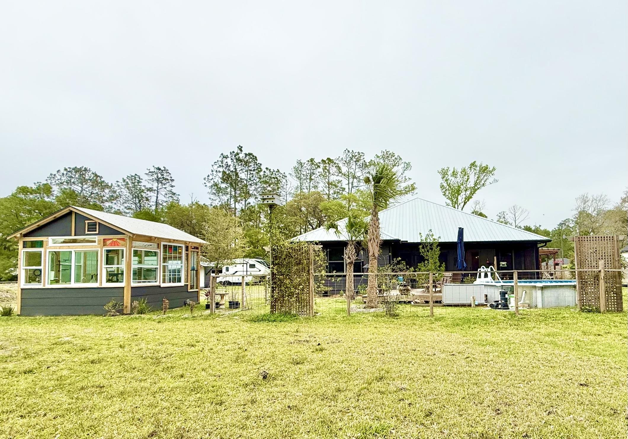 146 Maple Tree Lane Elkton, FL 32033 - Photo 61 of 75 a front view of a building with a garden