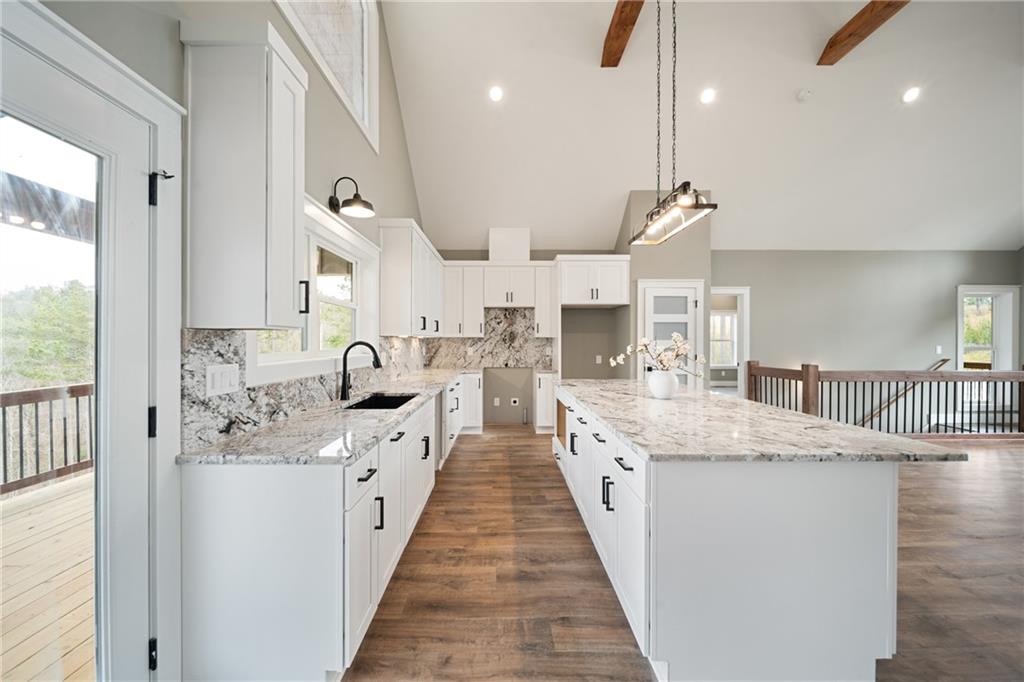 2956 Blalock Mountain Road Talking Rock, GA 30175 - Photo 17 of 65 a large kitchen with stainless steel appliances kitchen island a large counter tops and white cabinets