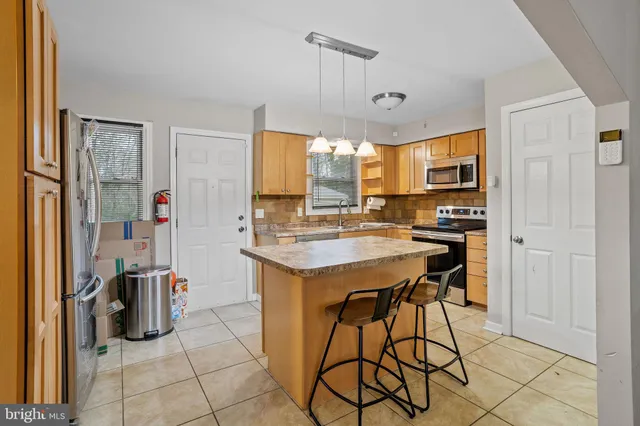 a kitchen with a sink refrigerator and cabinets