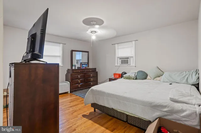 a bedroom with a bed and dresser with mirror