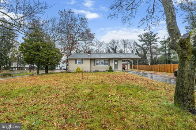 a front view of house with yard and trees