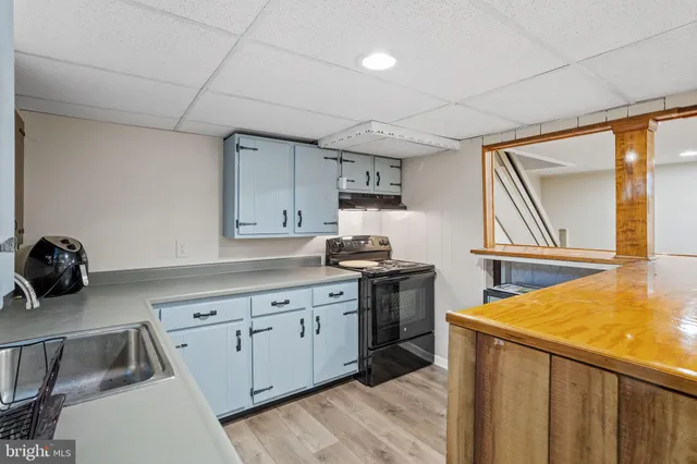 a kitchen with a sink appliances and cabinets