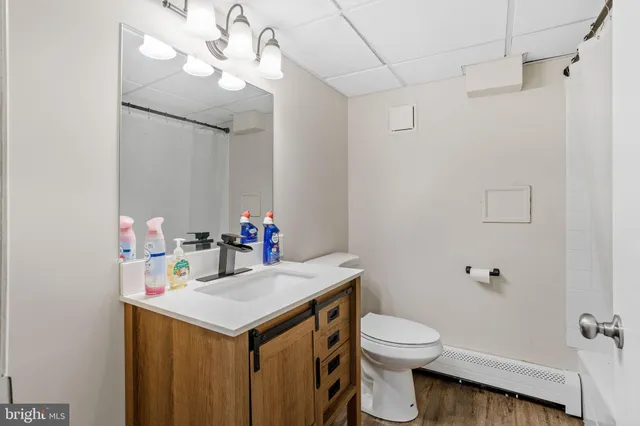 a bathroom with a sink vanity mirror and toilet