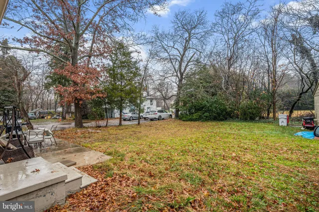 a view of yard with tree and wooden fence