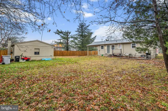 a front view of house with yard and trees around