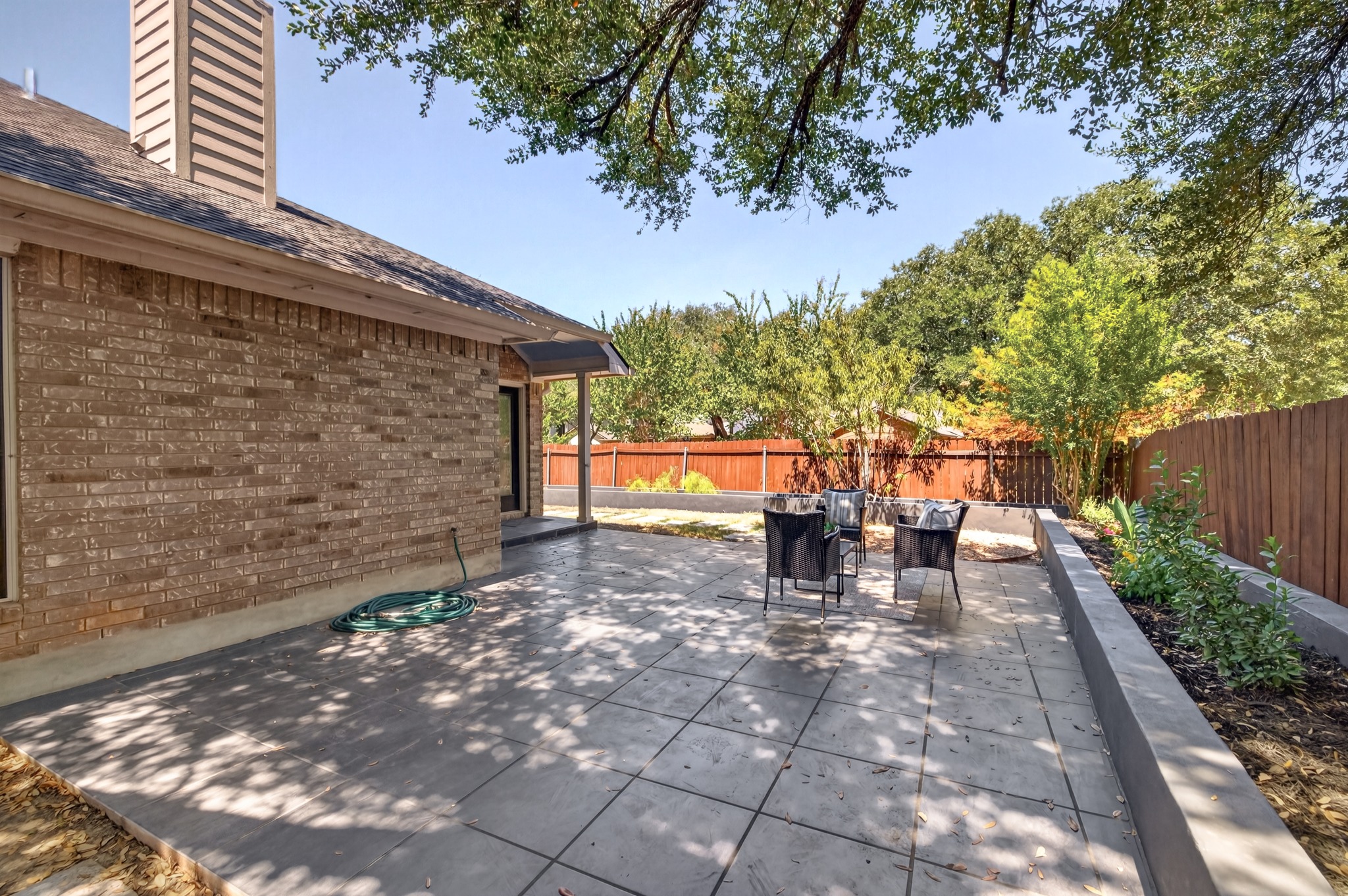 13536 Anarosa Loop Austin, TX 78727 - Photo 30 of 31 Overhead tree branches keep the patio cooler during afternoon sun, making outdoor relaxation comfortable throughout the seasons