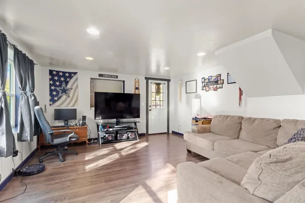 a living room with furniture and a flat screen tv