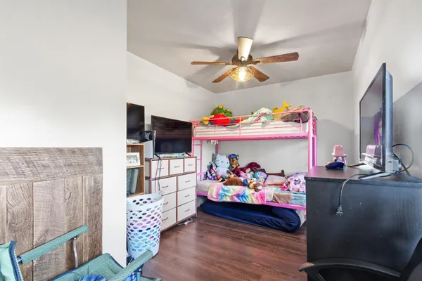 a bed room with furniture and wooden floor