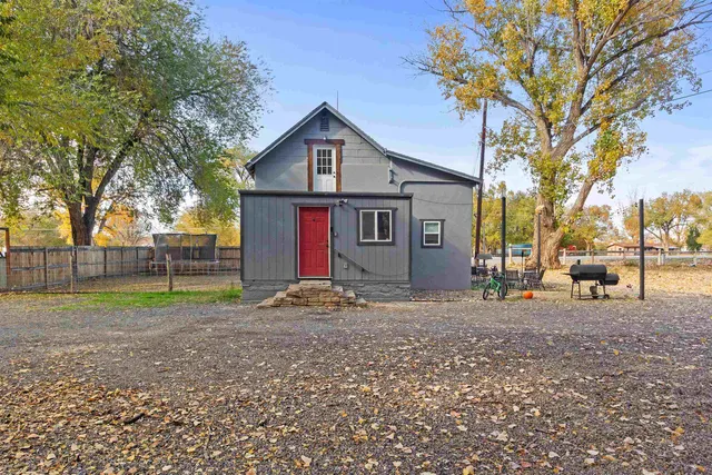 a view of a house with a yard covered in forest