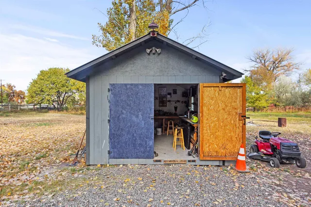 a view of a chair and table in backyard of the house