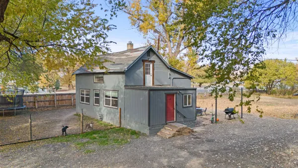 a view of a house with a yard and tree s