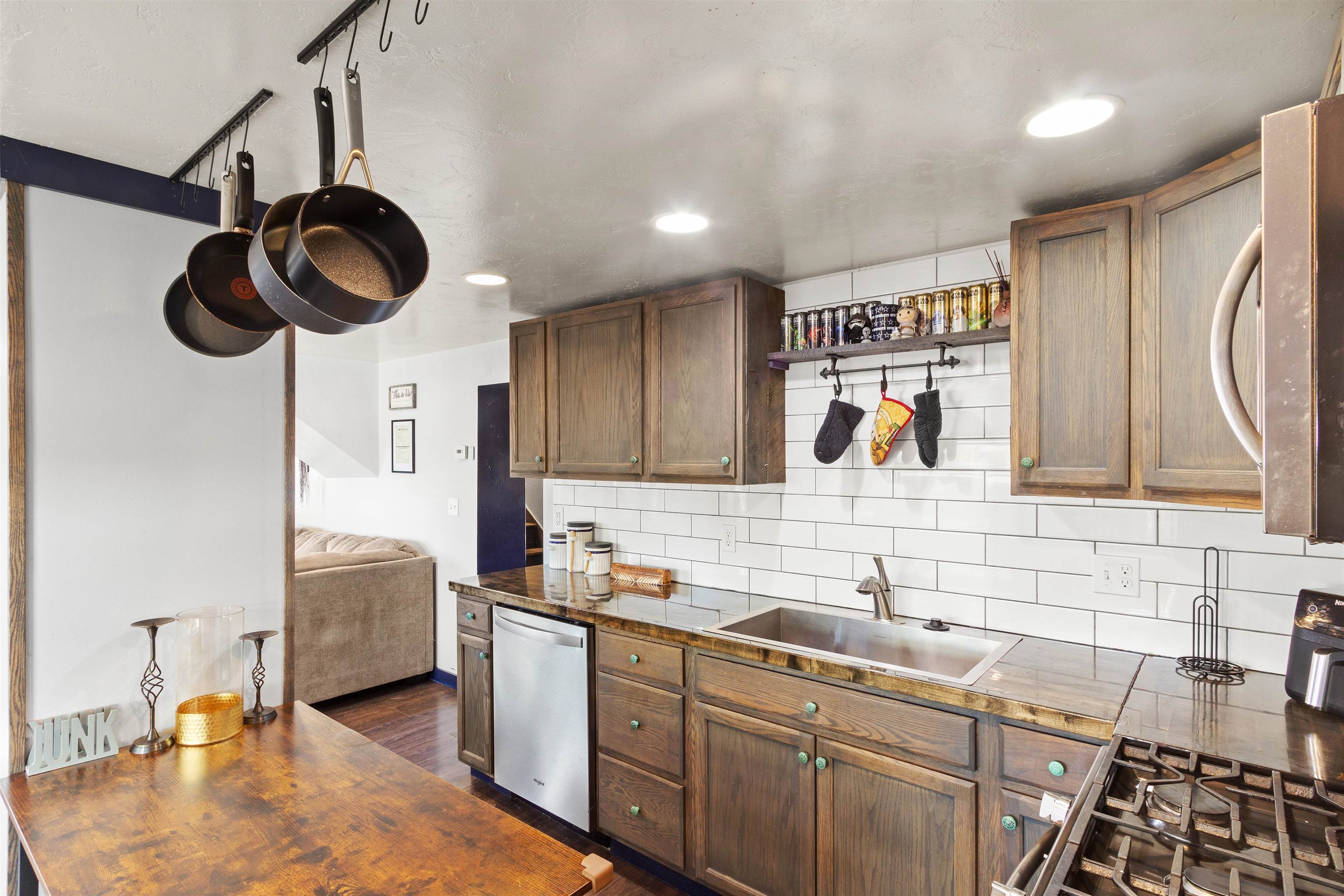 701 Highway 50 Delta, CO 81416 - Photo 4 of 31 a kitchen with stainless steel appliances granite countertop a sink a stove and a wooden floors