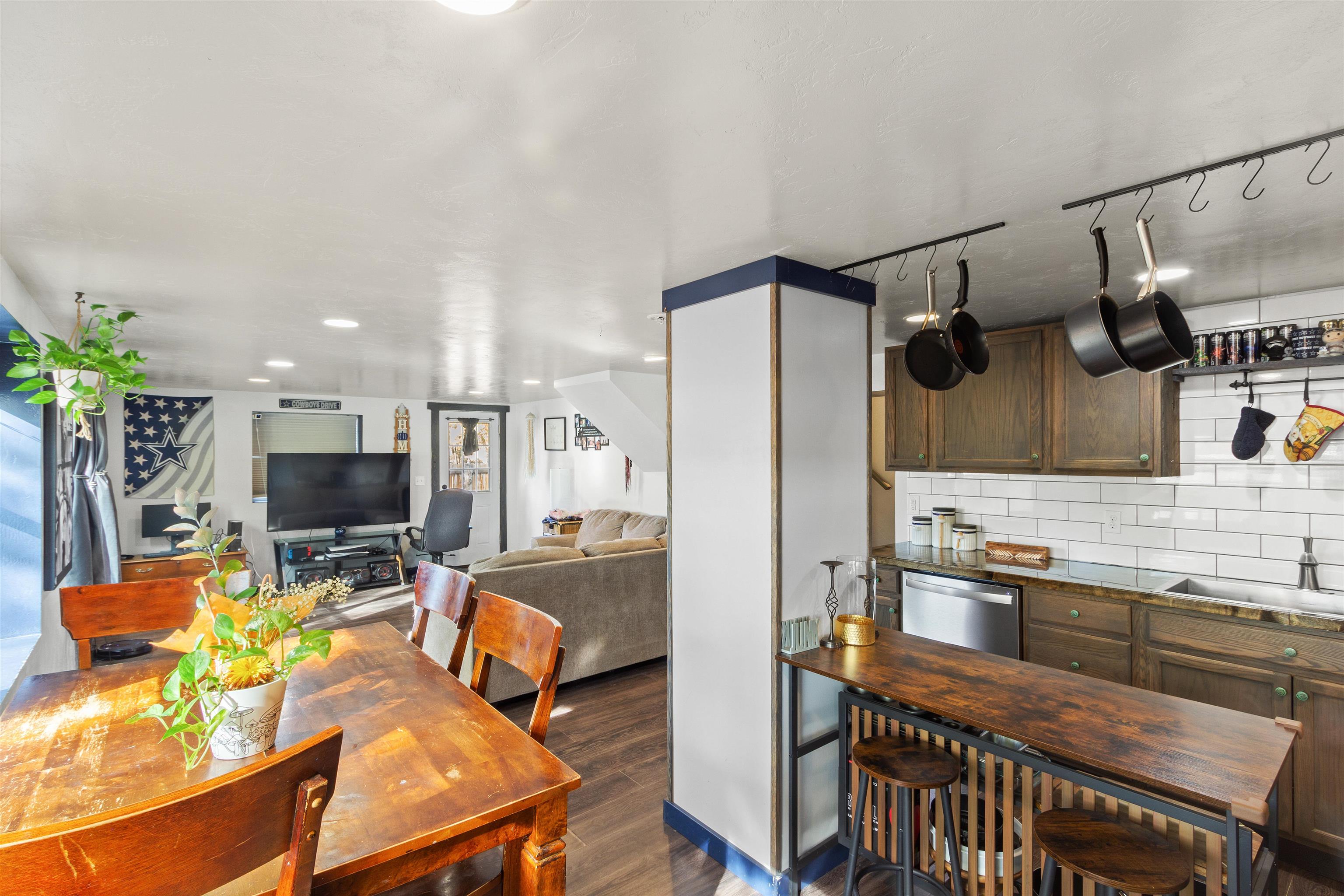 701 Highway 50 Delta, CO 81416 - Photo 8 of 31 a kitchen with stainless steel appliances granite countertop a stove top oven a sink dishwasher a dining table and chairs with wooden floor