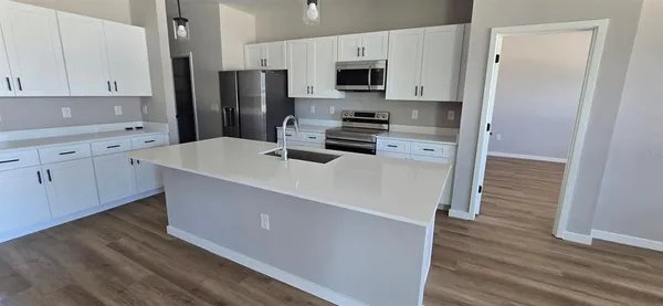 a kitchen with stainless steel appliances a refrigerator stove microwave and cabinets