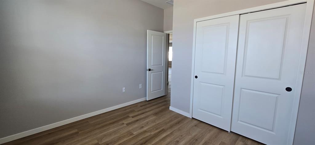 9975 Southwest 39th Terrace Ocala, FL 34476 - Photo 10 of 13 a view of an empty room with wooden floor