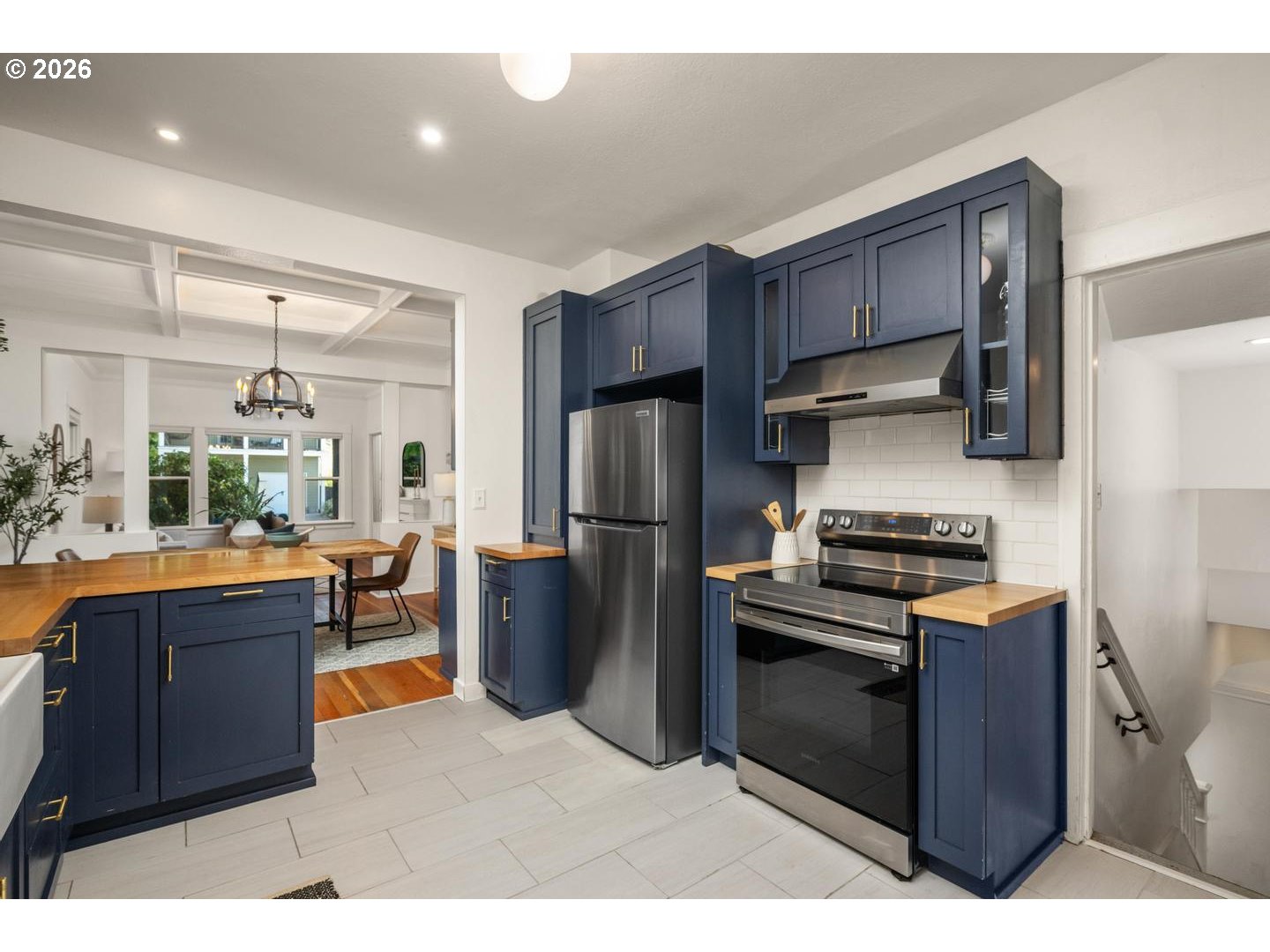 3725 North Baldwin Street Portland, OR 97217 - Photo 11 of 43 a kitchen with stainless steel appliances kitchen island granite countertop a stove refrigerator and cabinets