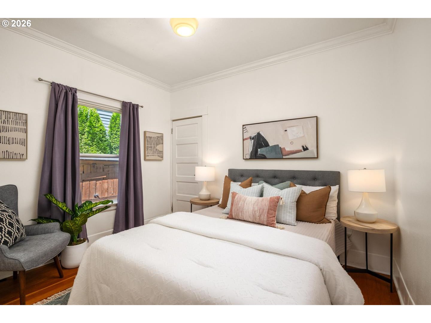 3725 North Baldwin Street Portland, OR 97217 - Photo 15 of 43 a bedroom with a large bed and potted plant
